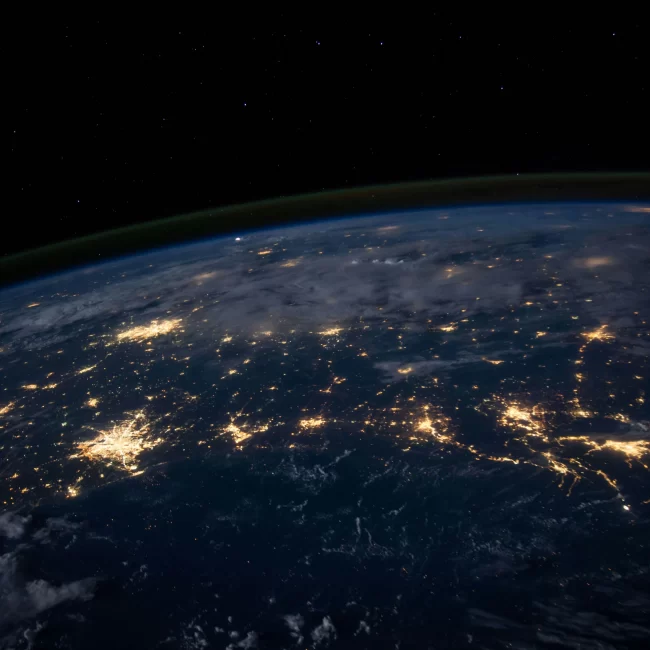 View of Earth from space at night colored navy with gold-tinged lights